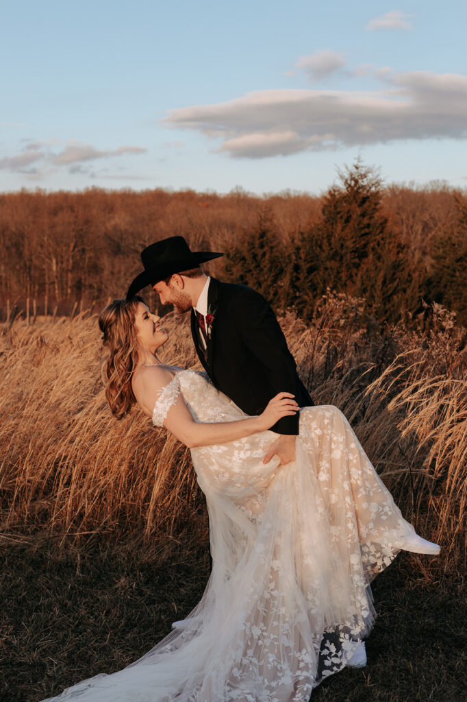 A bride and groom pose in a field during a Leesburg Virginia wedding. Wedding venue: 48 Fields Farm. Florist: One Last Avocado Floral Design