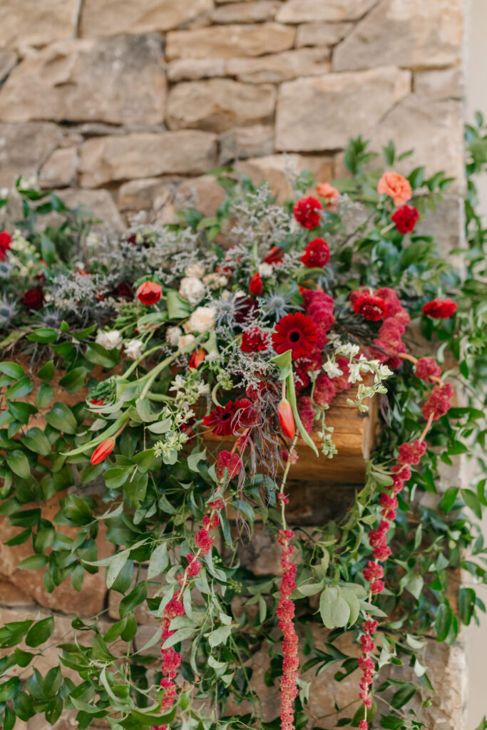 Stone fireplace wedding floral installation with romantic garden-style flowers in Virginia
