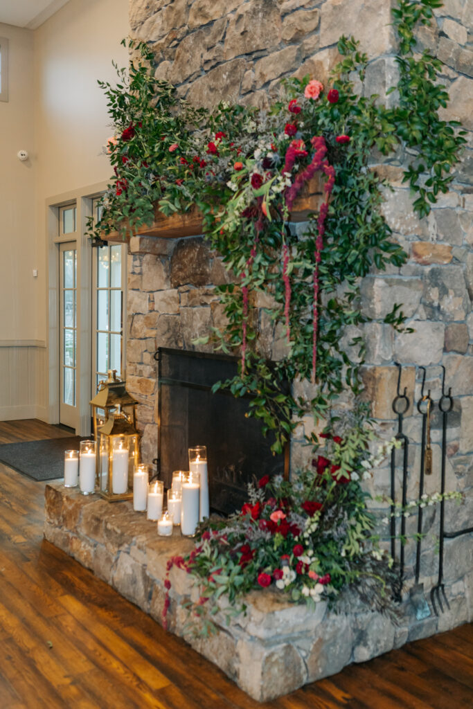 Romantic wedding ceremony fireplace installation with greenery climbing stone chimney in Crozet Virginia