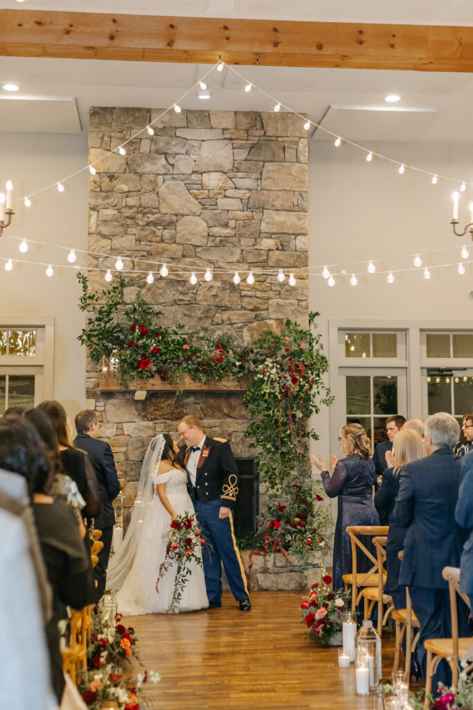 Garden-style floral meadow with candles and lanterns for cozy indoor winter wedding ceremony