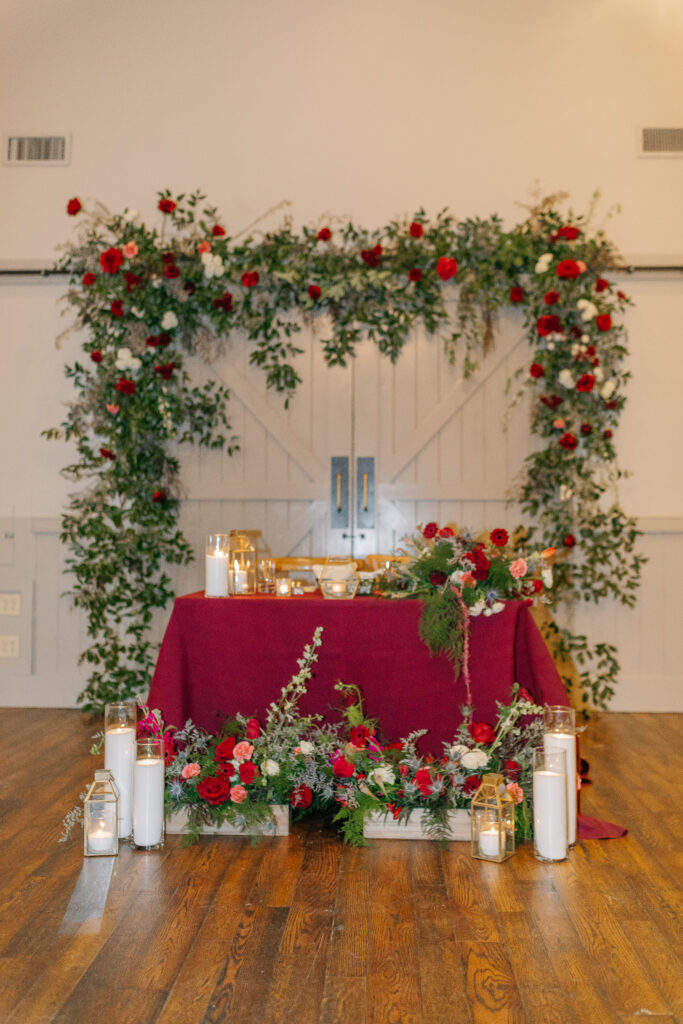 Layered winter floral installation framing sweetheart table at King Family Vineyards wedding