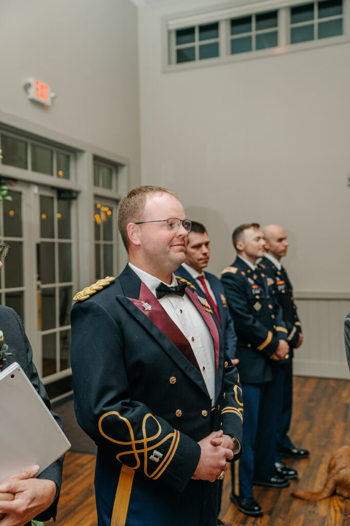 Romantic indoor wedding ceremony aisle with garden-style florals and glowing candlelight