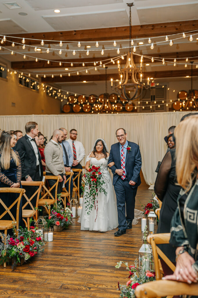 Winter wedding aisle meadow with red, blue, and white florals at King Family Vineyards