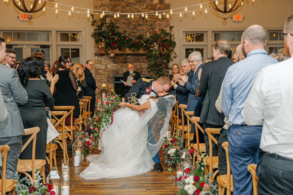Romantic wedding aisle meadow with lanterns, candles, and colorful garden-style winter flowers at King Family Vineyards