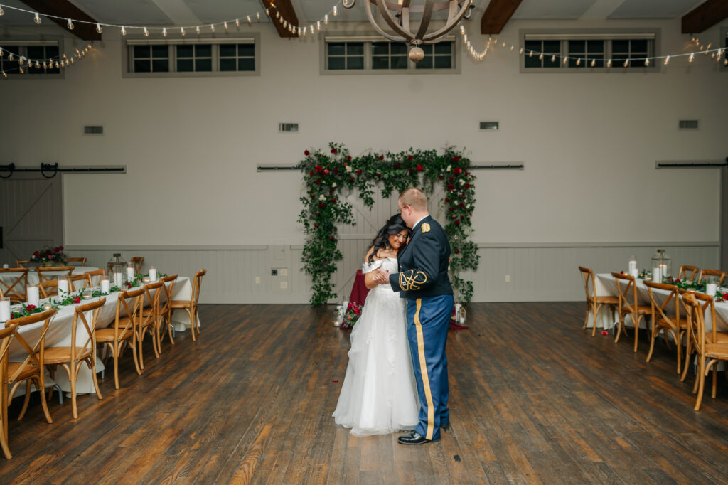 Romantic sweetheart table floral installation with colorful red garden-style winter flowers at King Family Vineyards