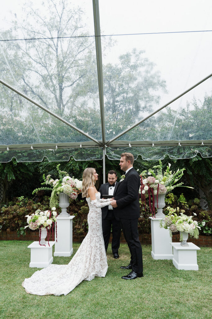 Bride and groom with sculptural hydrangeas and dahlias floral installation at The Clifton Charlottesville wedding venue