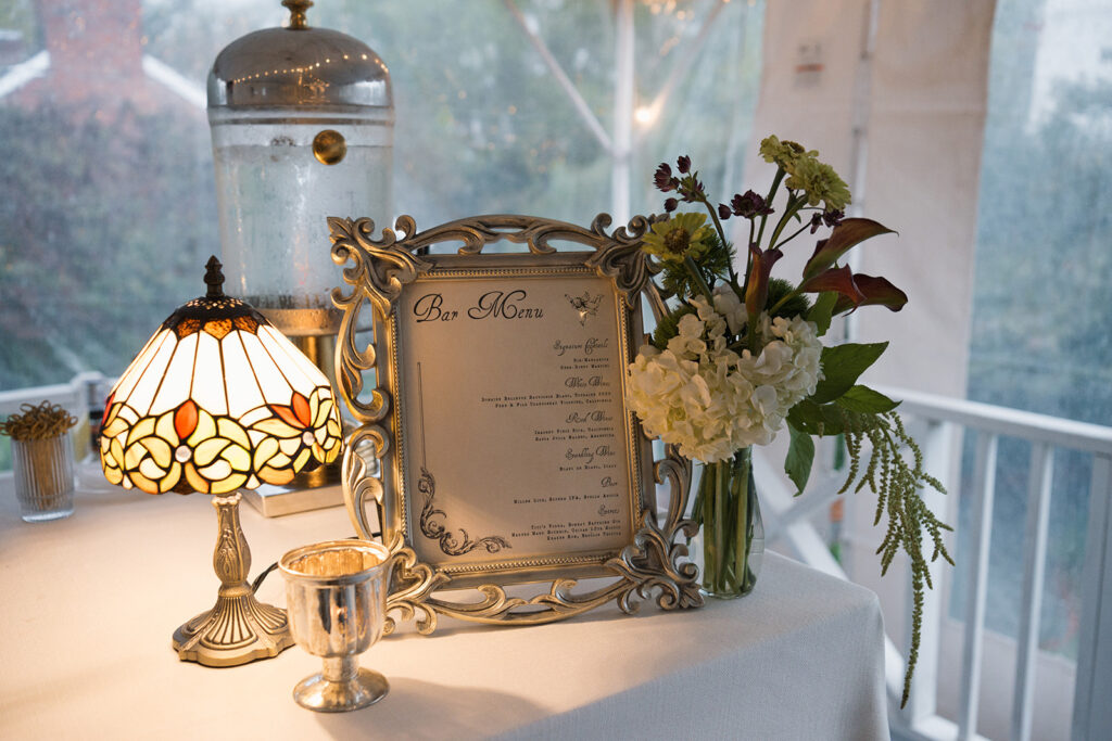 Luxury wedding table styling with chartreuse hydrangeas, burgundy dahlias, and hanging amaranthus at The Clifton