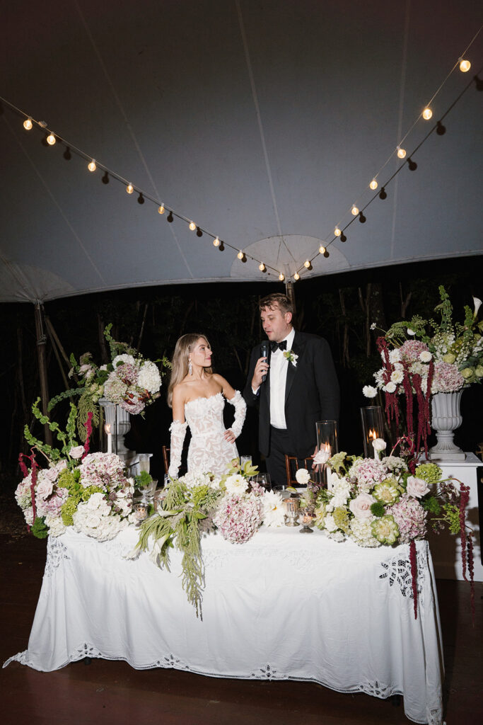 Modern candlelit wedding table with sculptural florals and layered greenery at The Clifton Charlottesville